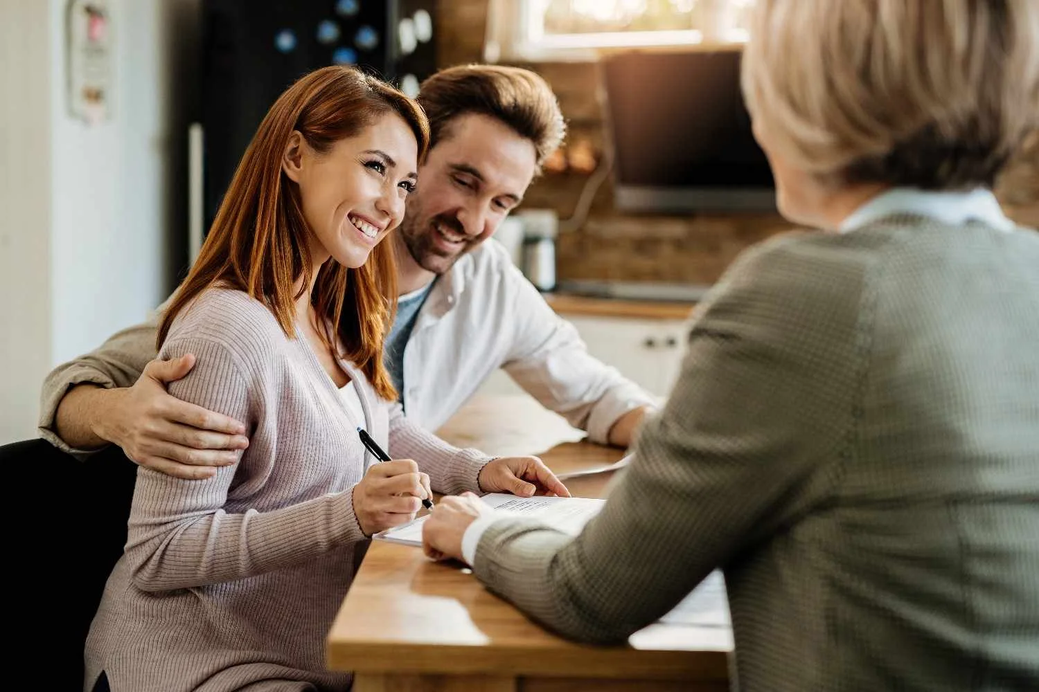 Household reviewing insurance paperwork at a kitchen table
